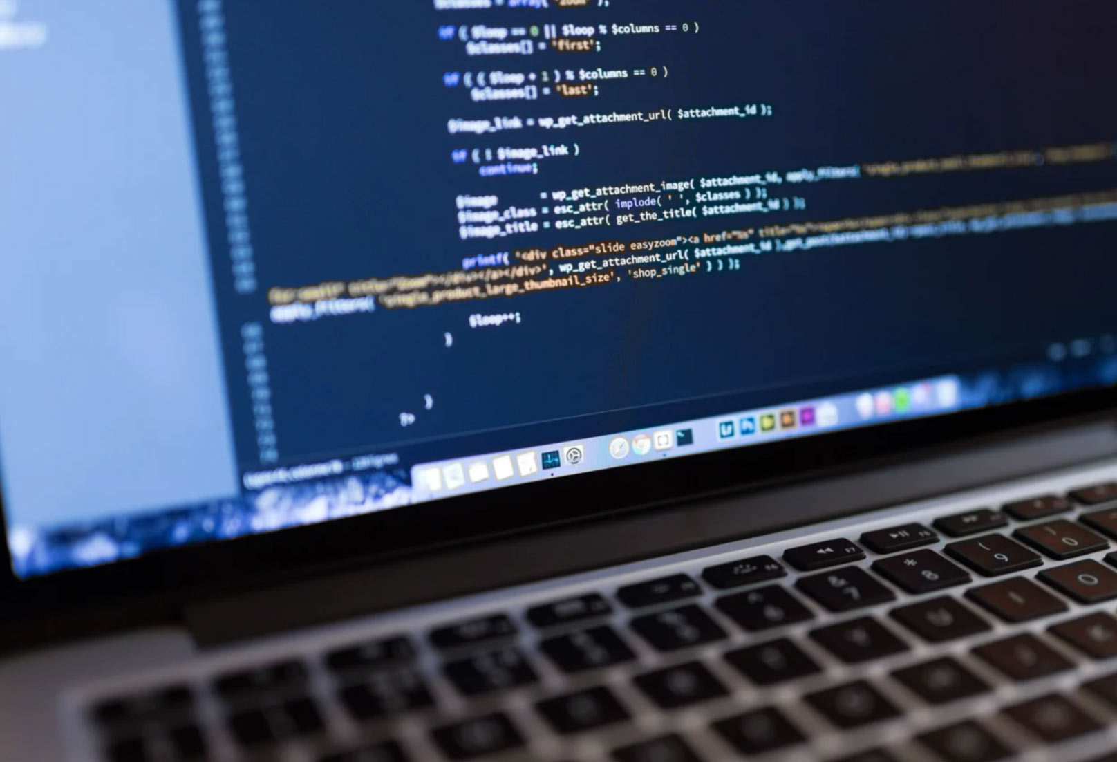 A laptop screen displaying lines of code on a text editor or integrated development environment.