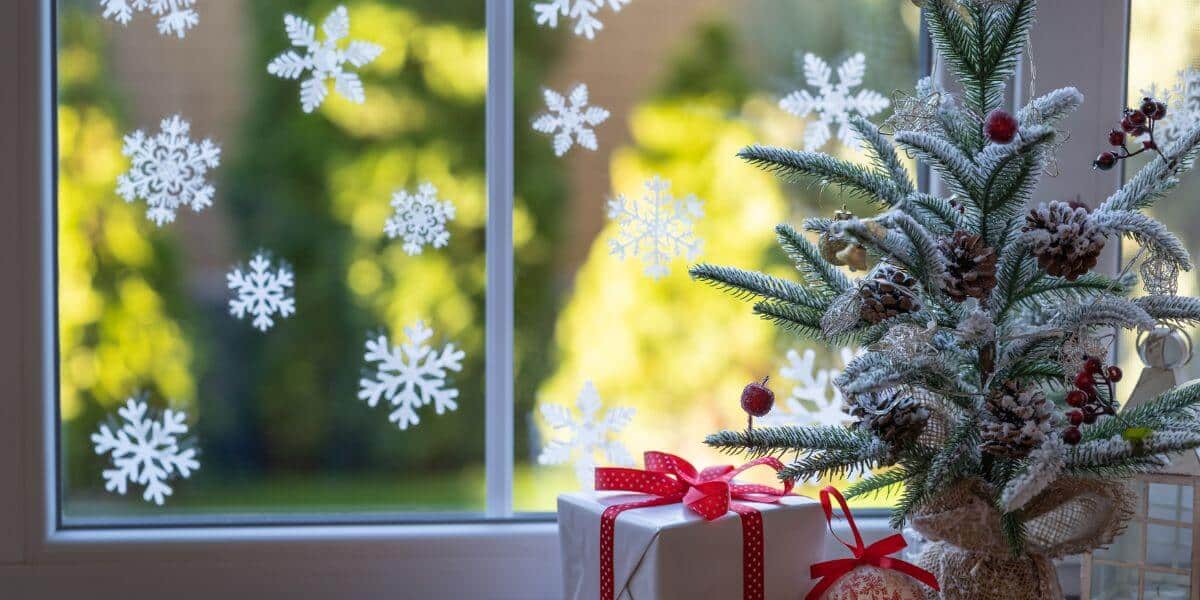 Festive Christmas Window Decor: Christmas Tree Decorations on the Window Sill and Snowflake Window Clings Festive Christmas Window Decor: Christmas Tree Decorations on the Window Sill and Snowflake Window Clings